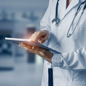Medical professional using digital tablet for patient diagnosis